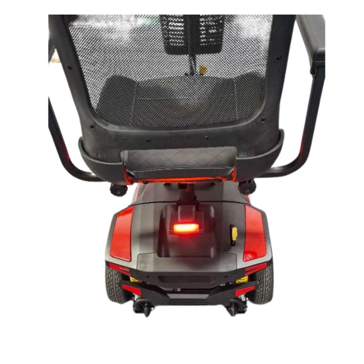 Back view of a mobility scooter with a red light on a white background