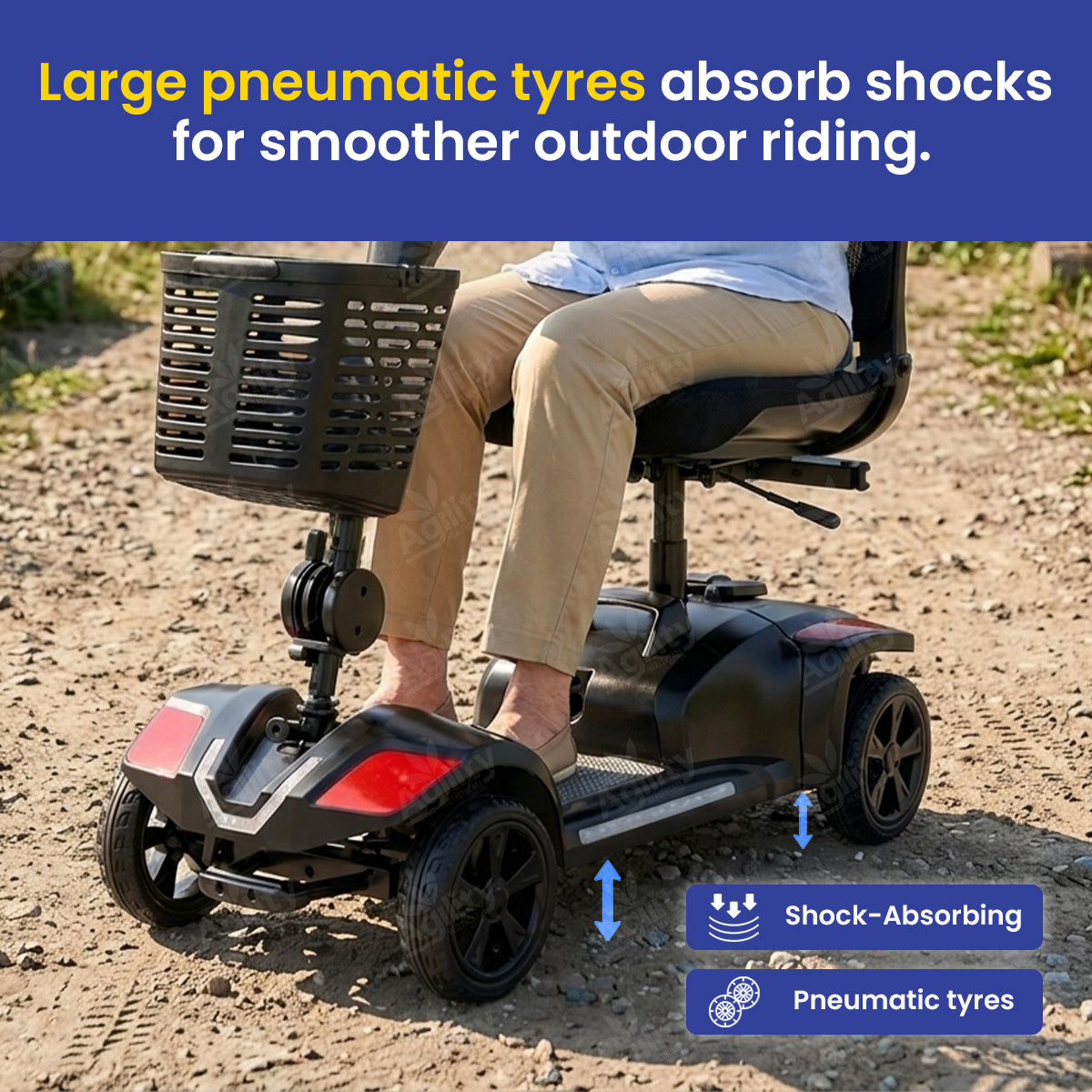 A person is using a Bandit Z Zero-Turn Mobility Scooter with large pneumatic tyres on a dirt path, highlighting the shock-absorbing feature.