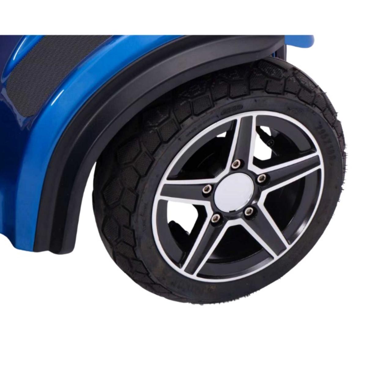 Close-up of a Blazer Pro TopGun  blue Mobility Scooter with black tire and silver rim on a white background