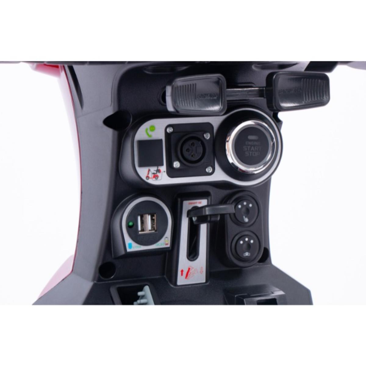 Close-up of a Blazer Pro TopGun scooter power outlet and control panel with various ports and buttons.