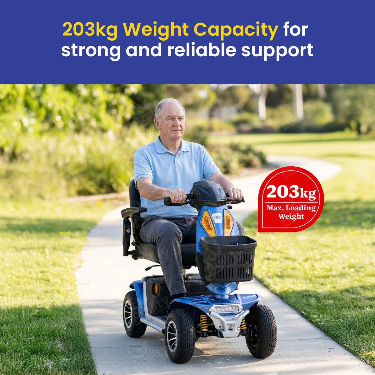 Man using a charger mobility scooter with text about weight capacity in an outdoor setting