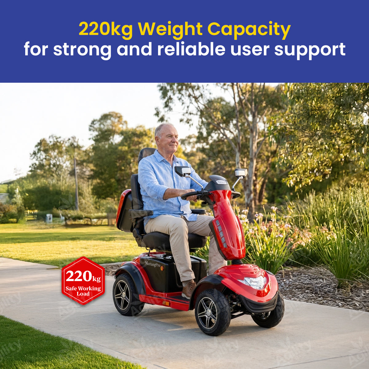 A man using a red Mustang Pro Heavy Duty mobility scooter with text about weight capacity in an outdoor setting.