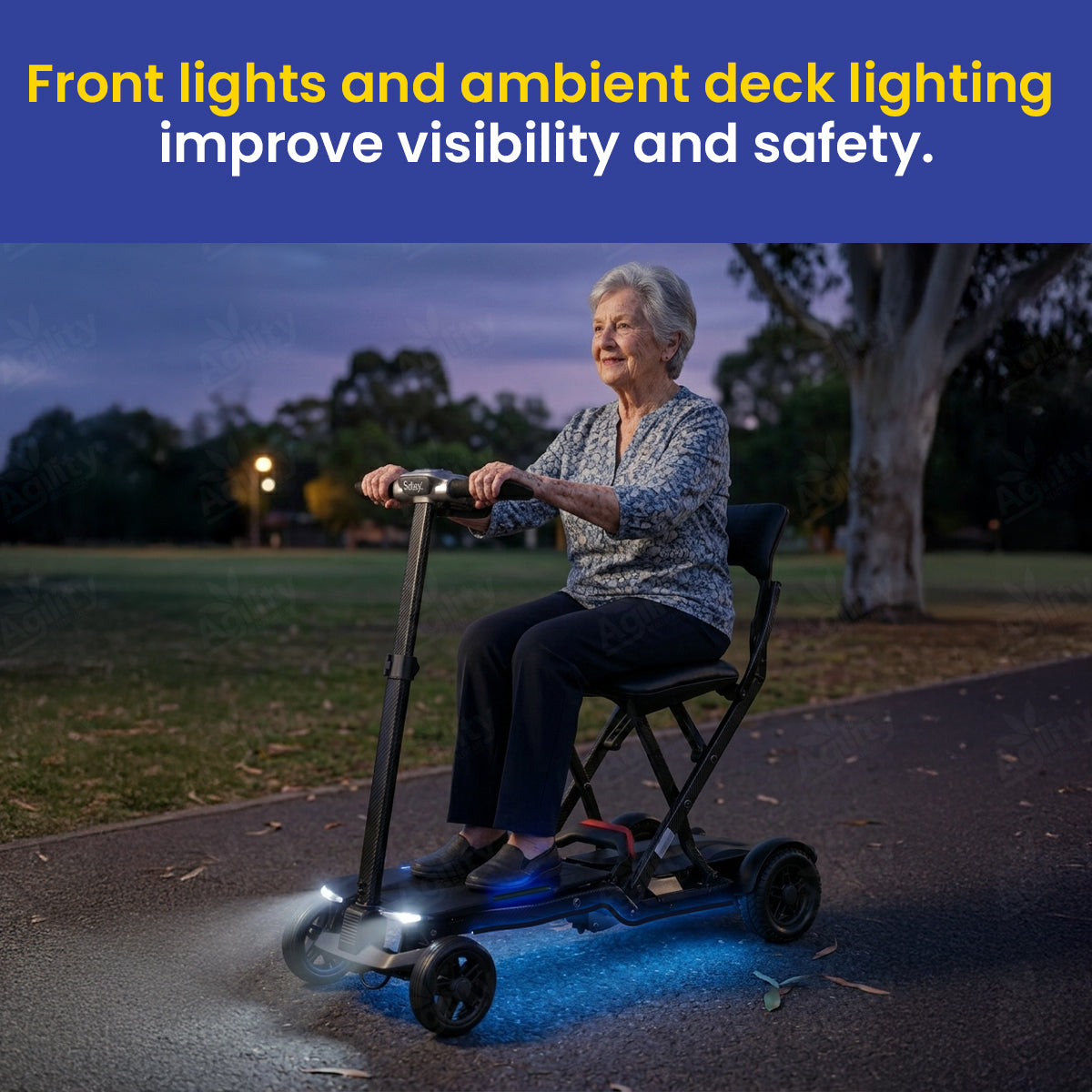 Woman riding a Solax Maleta Carbon Fibre Auto Folding Mobility Scooterwith front lights on a path at night, text about improved visibility and safety.