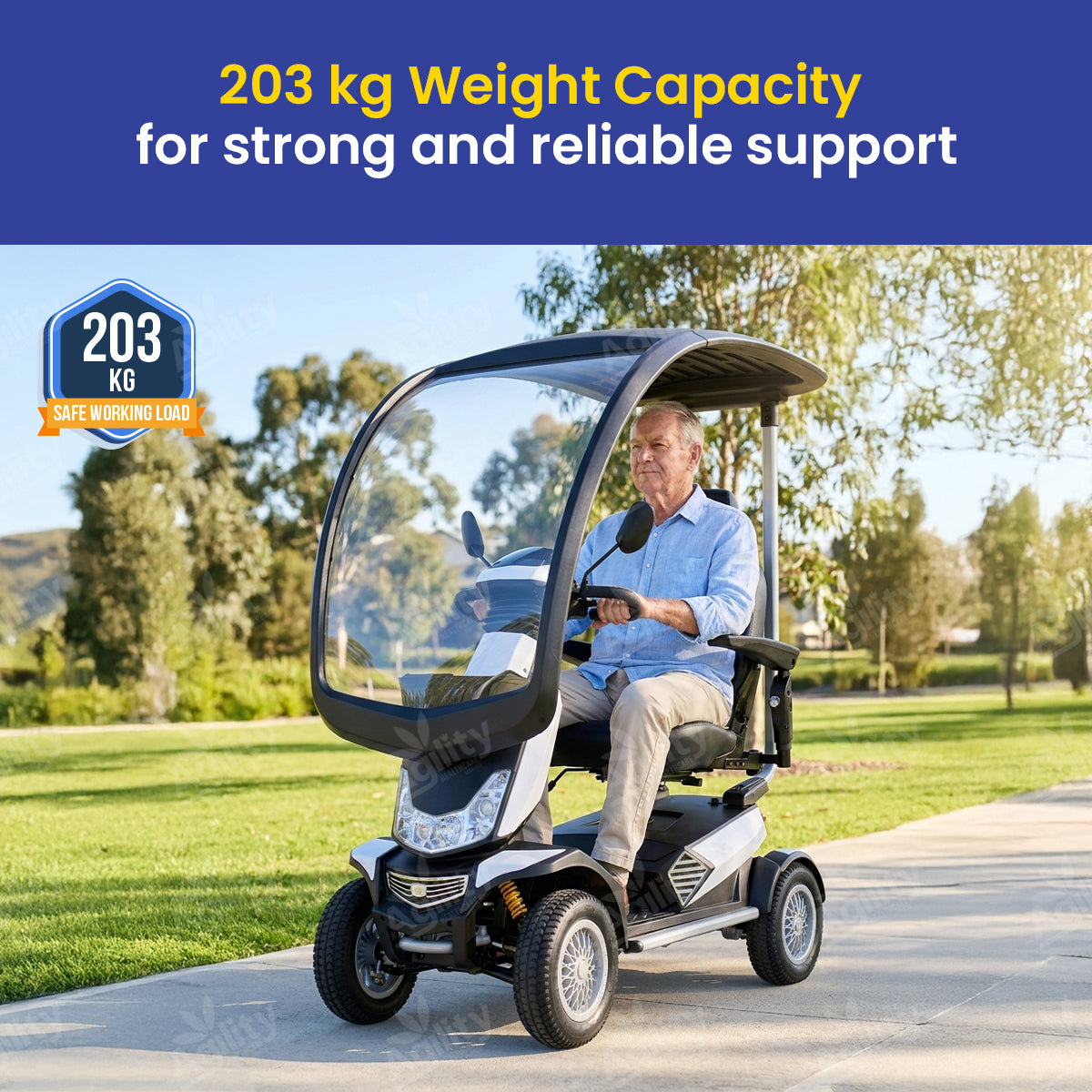 Man driving a safari mobility scooter with text about weight capacity on a scenic background
