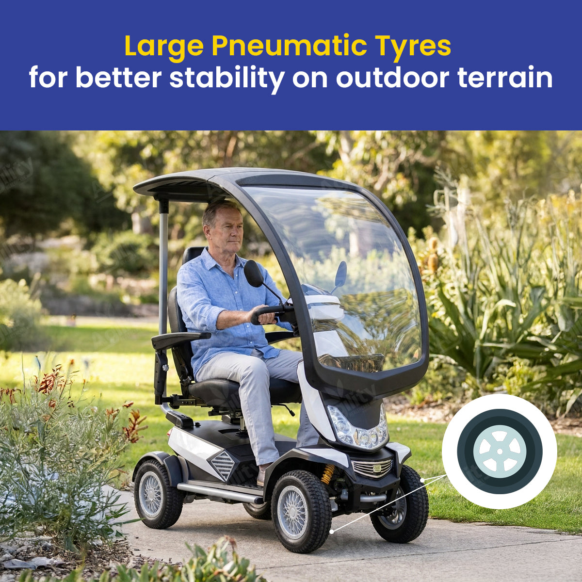 Man driving a safari mobility scooter with large pneumatic tyres in a park setting